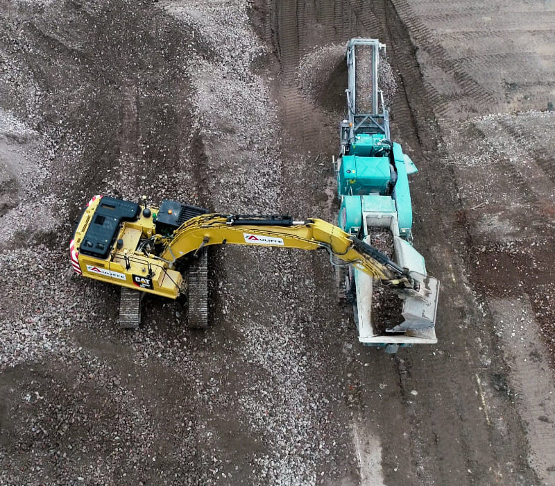 Ariel view of McAuliffe's remediation techniques involving heavy machinery to repurpose materials on site.