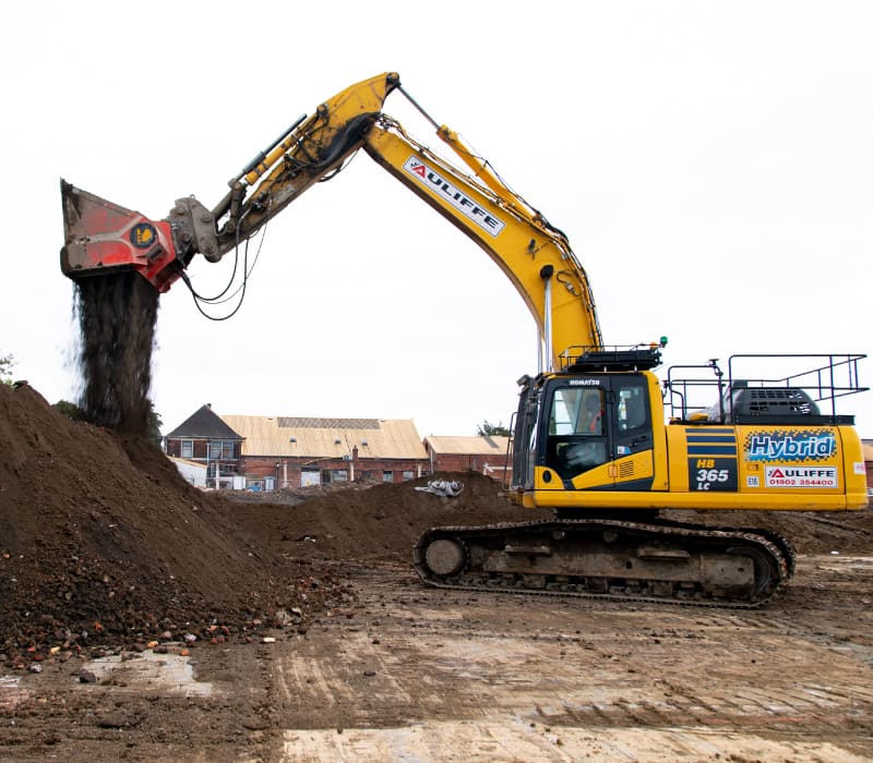 Yellow McAuliffe branded digger moving materials which saved 10,000 tonnes of material from landfill through excellent regulatory knowledge.