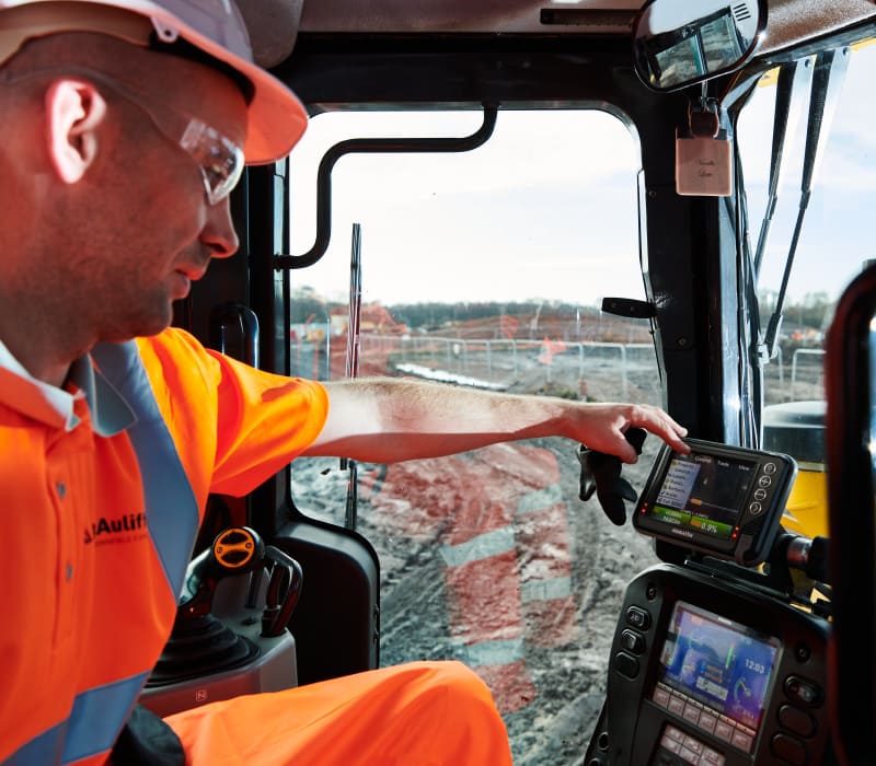 Inside of heavy remediation machinery featuring McAuliffe team member.
